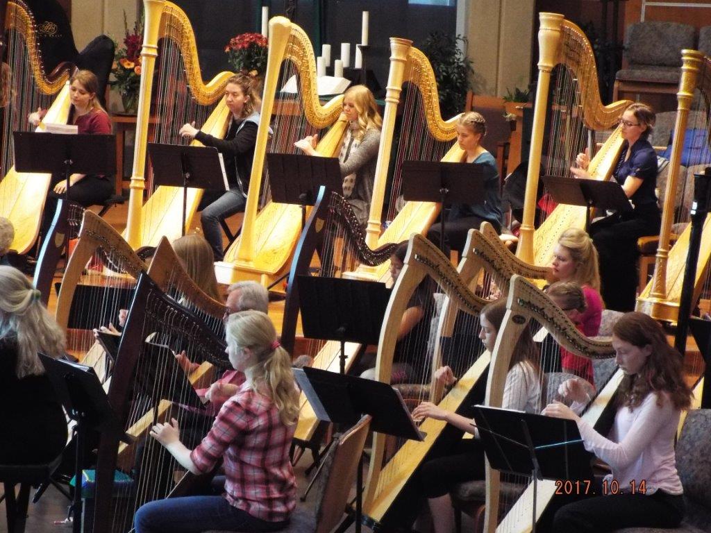 Barbara's students playing at the harp fantasia performance after taking harp lessons.